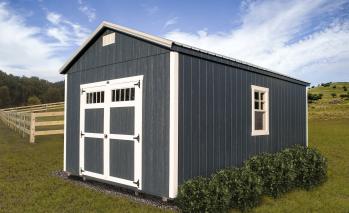 Gray-Blue Compass Big Sky Shed with white trim and double doors.