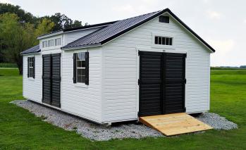 White Signature Louisville Shed with black roofing, black doors, and a ramp.